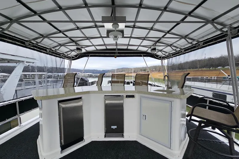 Slide: The Image of Covered deck area on a 2002 Lakeview 16x60 houseboat with bar and seating. - 53