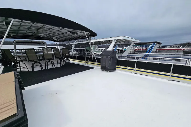 Slide: The Image of Upper deck of 2002 Lakeview 16x60 houseboat with seating and covered area. - 57