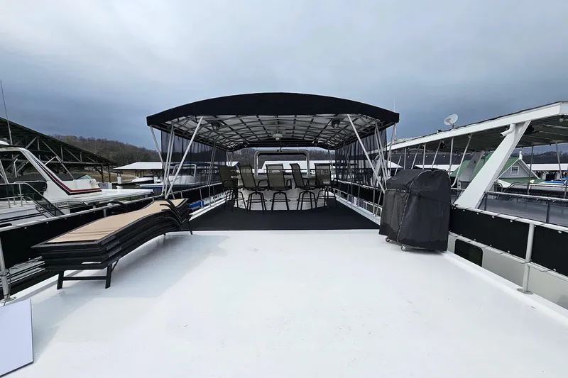 Slide: The Image of 2002 Lakeview 16x60 houseboat with covered deck and seating area. - 58