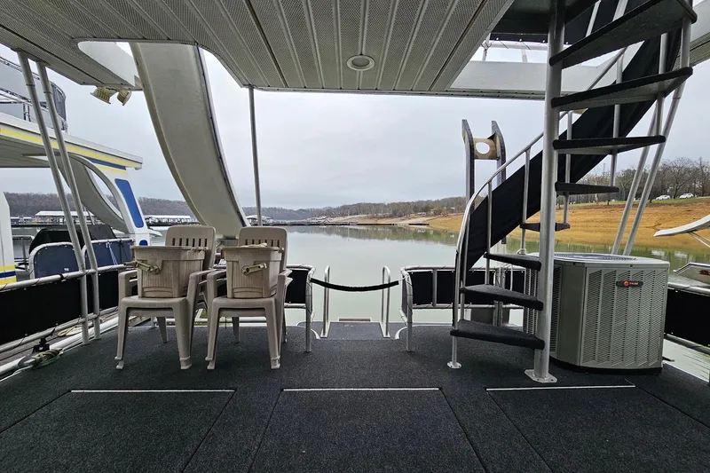 Slide: The Image of Houseboat deck with spiral staircase, chairs, and lake view; Lakeview 16x60, 2002 model. - 9