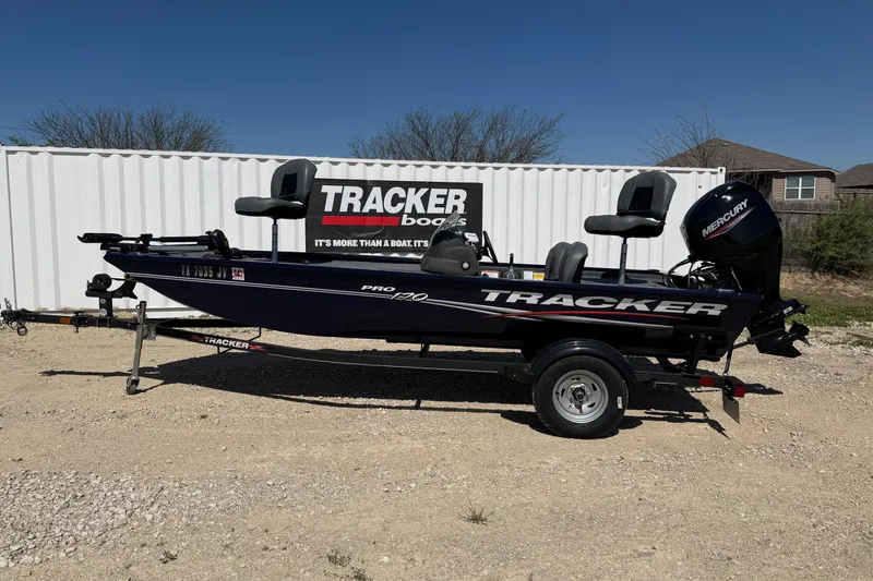 The Image of 2021 Tracker Pro 170 boat on trailer, displayed outdoors with Mercury engine. - 0