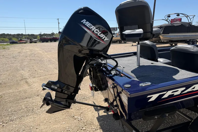 Slide: The Image of 2021 Tracker Pro 170 boat with Mercury outboard motor in a gravel lot. - 3