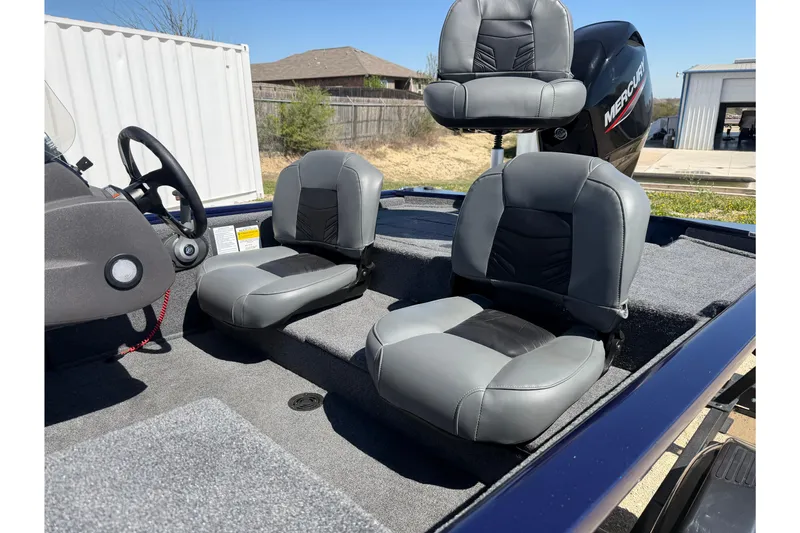 Slide: The Image of 2021 Tracker Pro 170 boat interior with gray seats and Mercury engine. - 6