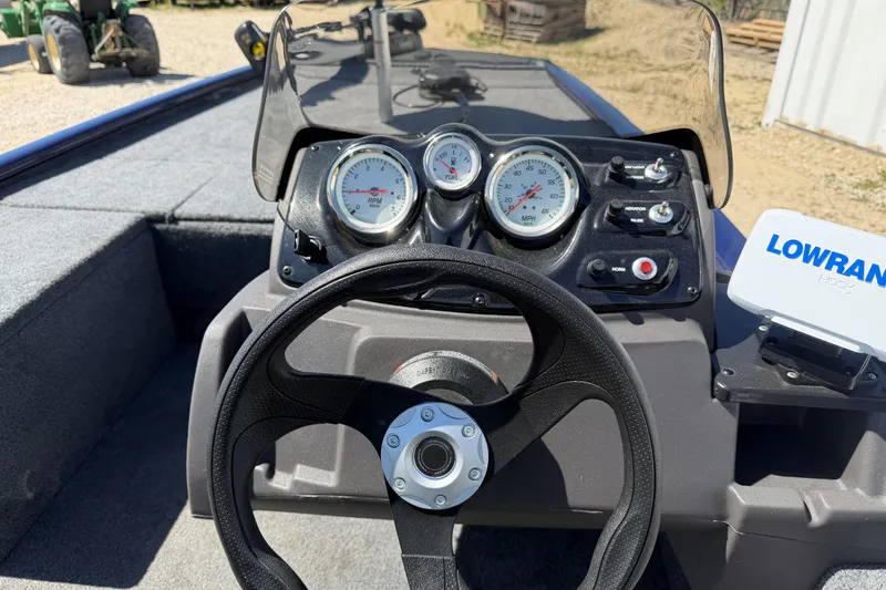 Slide: The Image of 2021 Tracker Pro 170 boat dashboard with steering wheel and gauges. - 8