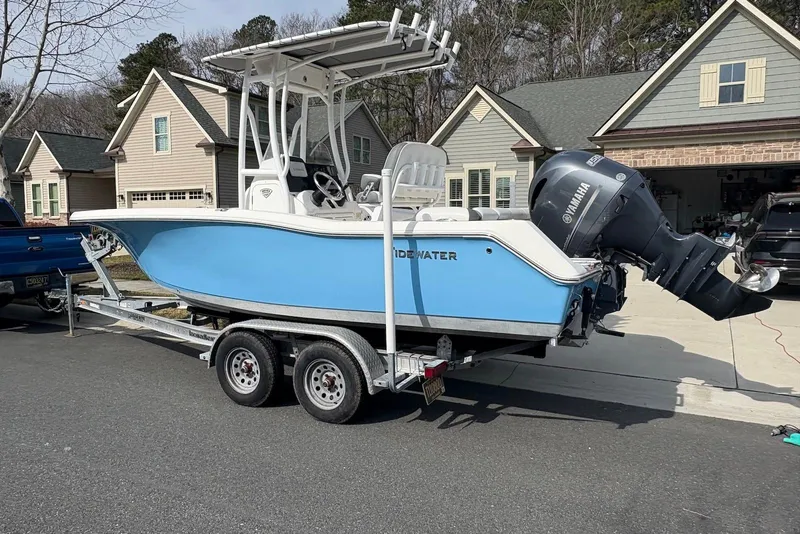 The Image of 2019 Tidewater 210 LXF boat on trailer, parked in residential driveway. - 0