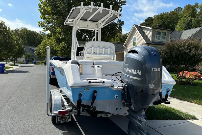 Slide: The Image of 2019 Tidewater 210 LXF boat with Yamaha 150 engine on a residential street. - 2