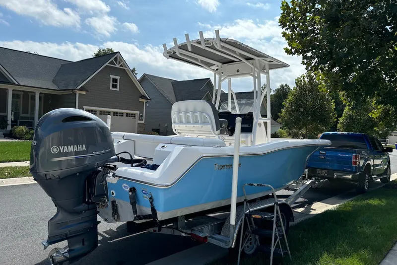 Slide: The Image of 2019 Tidewater 210 LXF boat on trailer, parked in suburban neighborhood. - 3