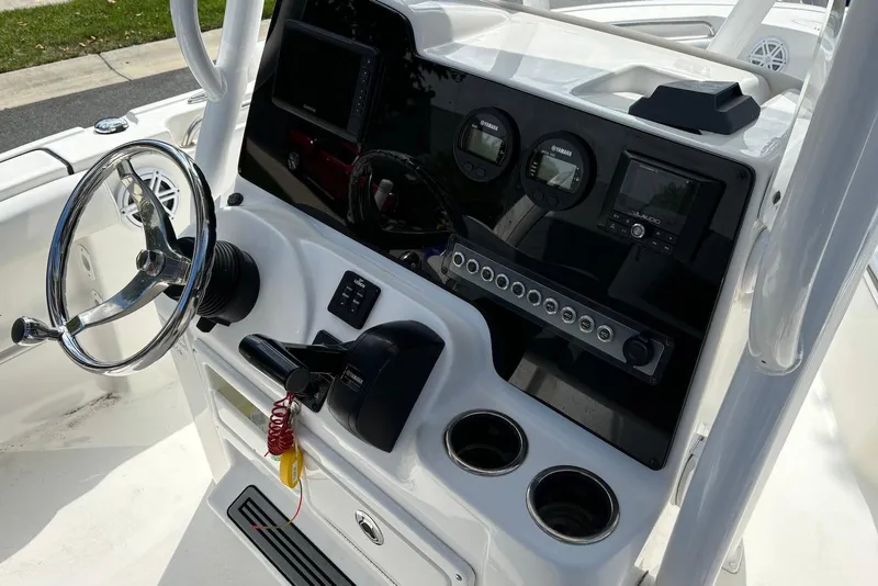 Slide: The Image of 2019 Tidewater 210 LXF boat dashboard with steering wheel and control panel. - 5