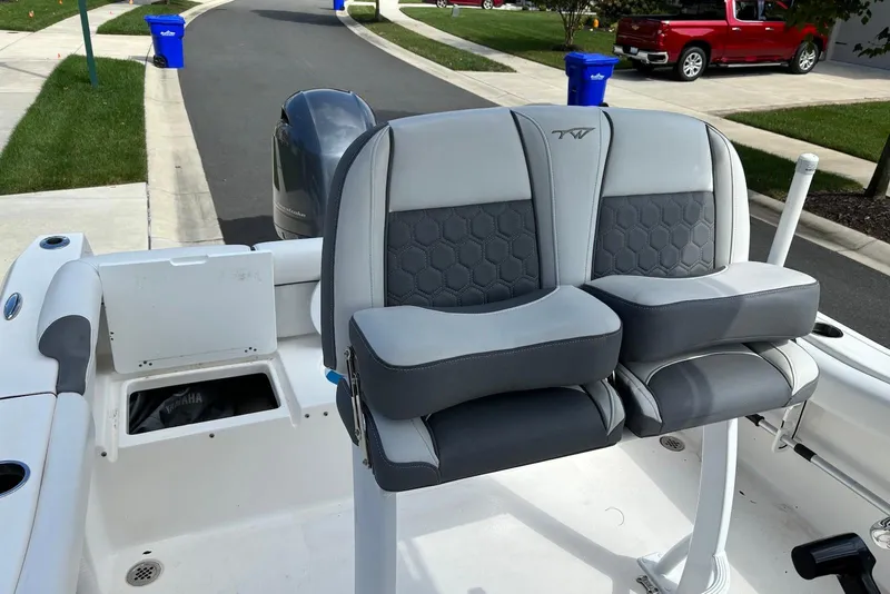 Slide: The Image of 2019 Tidewater 210 LXF boat seats with gray upholstery, parked in a residential area. - 6