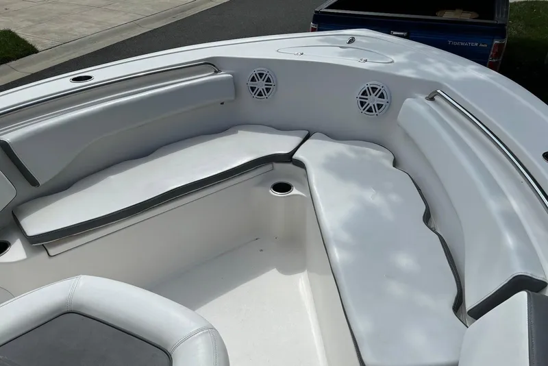 Slide: The Image of 2019 Tidewater 210 LXF boat interior with cushioned seating and built-in speakers. - 7