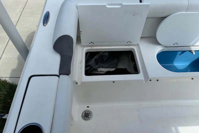 Slide: The Image of 2019 Tidewater 210 LXF boat storage compartments with open hatches and visible interior. - 9