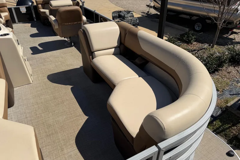Slide: The Image of 2024 Lowe SS 230 pontoon boat with beige seating and spacious deck layout. - 10