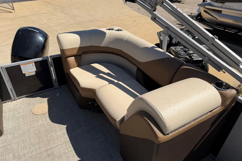 Slide: The Image of 2024 Lowe SS 230 boat interior with beige seating and cup holders. - 6