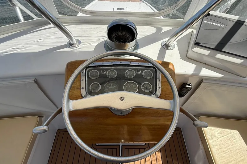 Slide: The Image of 1963 Rybovich 45 Convertible boat helm with vintage steering wheel and gauges. - 11