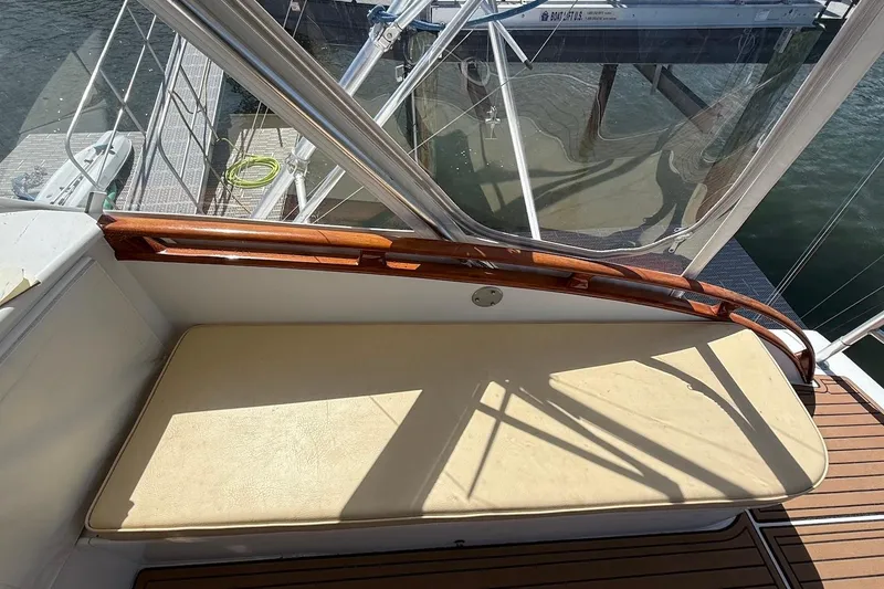 Slide: The Image of 1963 Rybovich 45 Convertible boat with cushioned seating and wooden railings. - 12
