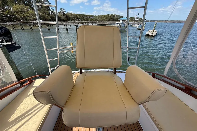 Slide: The Image of Captain's chair on 1963 Rybovich 45 Convertible yacht, overlooking serene waters. - 13
