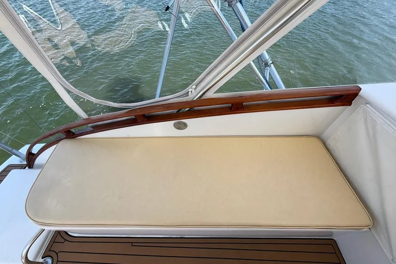 Slide: The Image of 1963 Rybovich 45 Convertible boat interior with cushioned seating and wooden accents. - 14