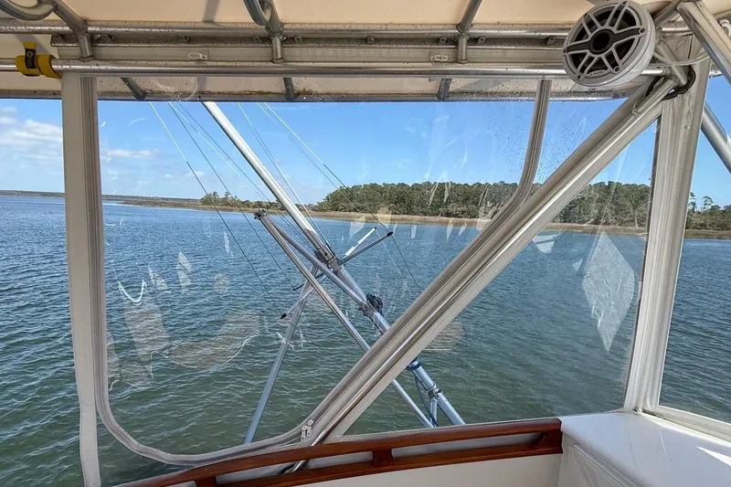 Slide: The Image of 1963 Rybovich 45 Convertible boat interior with water and shoreline view. - 17
