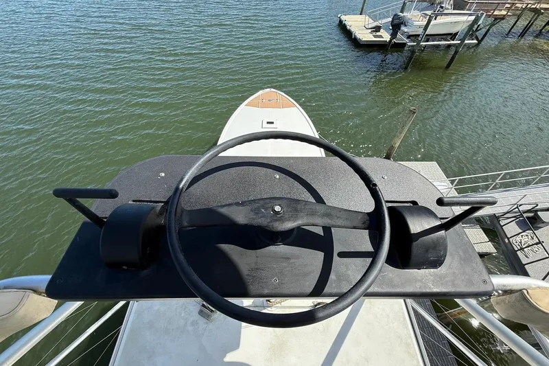 Slide: The Image of 1963 Rybovich 45 Convertible boat helm overlooking marina and water. - 19