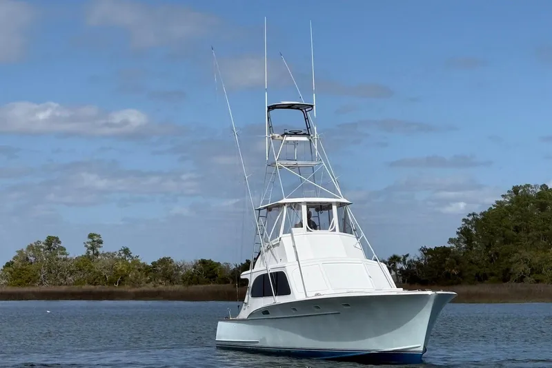 Slide: The Image of 1963 Rybovich 45 Convertible boat on calm water under blue sky. - 2