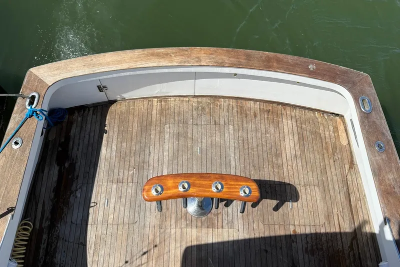 Slide: The Image of 1963 Rybovich 45 Convertible boat deck with wooden finish and fishing rod holders. - 20