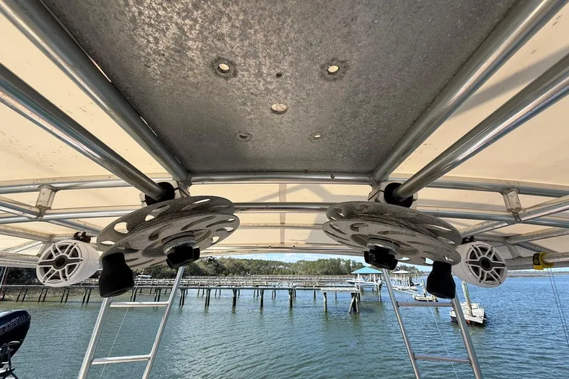 Slide: The Image of 1963 Rybovich 45 Convertible boat with custom roof speakers and scenic waterfront view. - 25