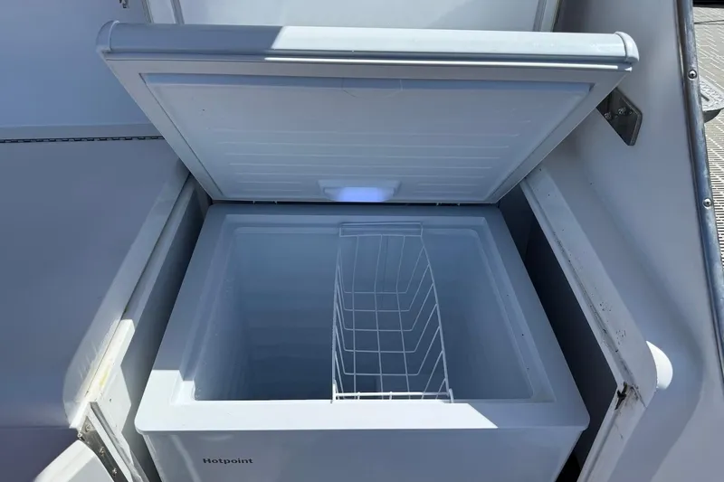 Slide: The Image of Open Hotpoint freezer on 1963 Rybovich 45 Convertible boat, showing interior storage space. - 29