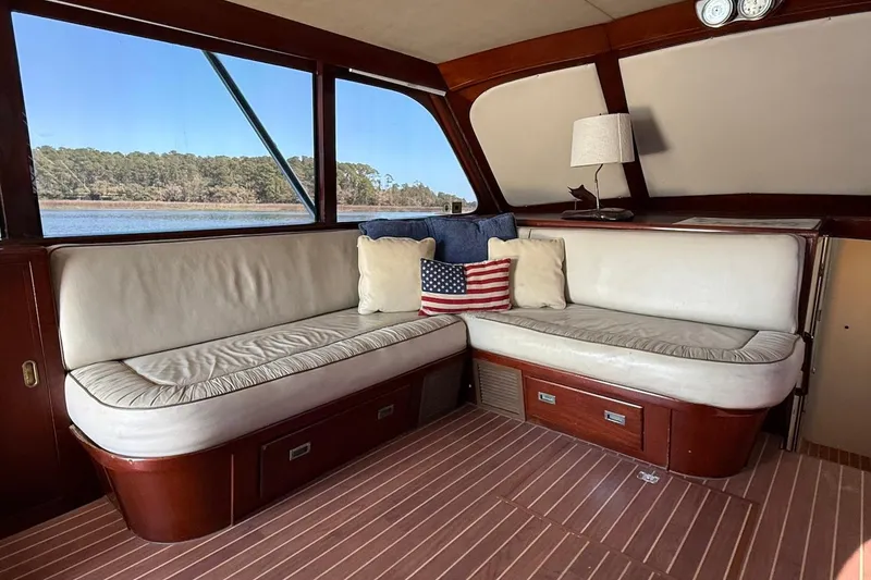 Slide: The Image of Interior of 1963 Rybovich 45 Convertible yacht with cozy seating and American flag pillow. - 31