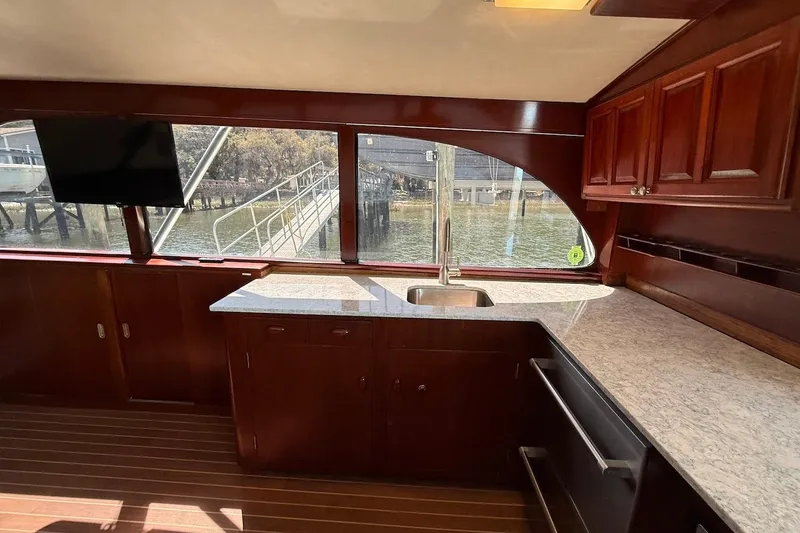 Slide: The Image of Interior of 1963 Rybovich 45 Convertible yacht with wooden cabinetry and waterfront view. - 34