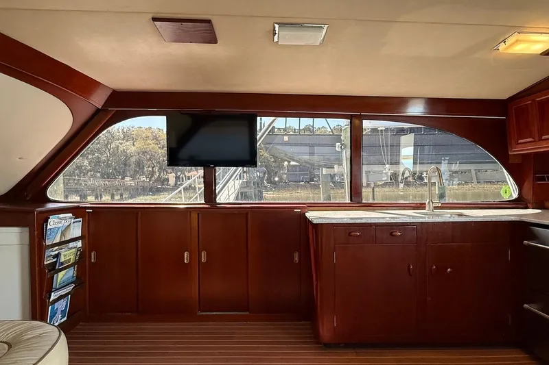 Slide: The Image of Interior of 1963 Rybovich 45 Convertible yacht with wood cabinetry and large windows. - 35