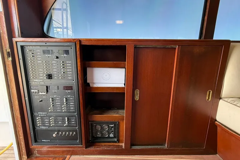 Slide: The Image of 1963 Rybovich 45 Convertible yacht interior with wooden cabinetry and electrical panel. - 39