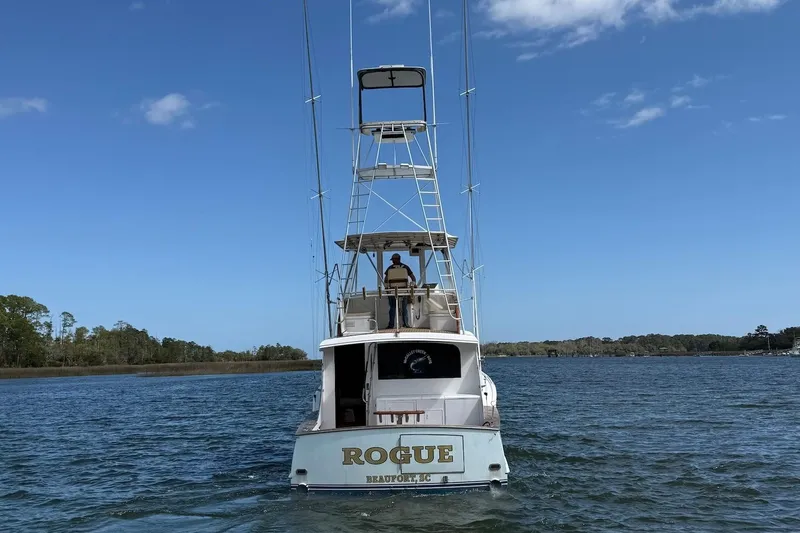 Slide: The Image of 1963 Rybovich 45 Convertible boat on water, clear sky, rear view. - 4