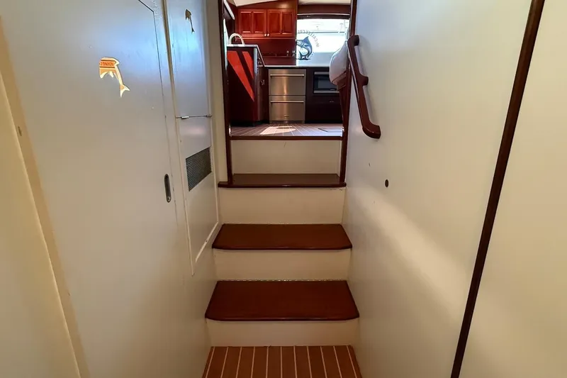 Slide: The Image of Interior stairs of a 1963 Rybovich 45 Convertible yacht, leading to the helm. - 41