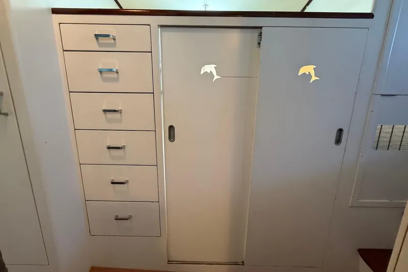 Slide: The Image of Interior cabinetry of a 1963 Rybovich 45 Convertible boat with drawers and sliding door. - 42