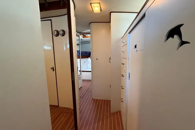 Slide: The Image of Interior of 1963 Rybovich 45 Convertible yacht, featuring wooden flooring and white cabinetry. - 43