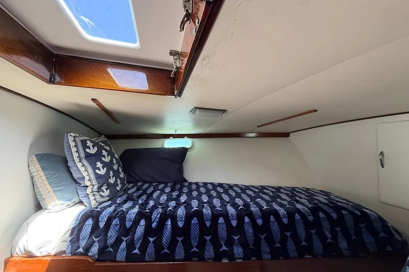 Slide: The Image of Cozy cabin interior of 1963 Rybovich 45 Convertible yacht with nautical-themed bedding. - 44