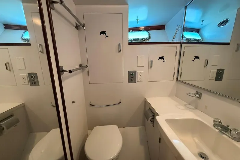 Slide: The Image of Bathroom interior of a 1963 Rybovich 45 Convertible yacht, featuring a sink and toilet. - 46