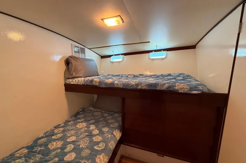 Slide: The Image of Interior cabin of 1963 Rybovich 45 Convertible with bunk beds and nautical decor. - 48