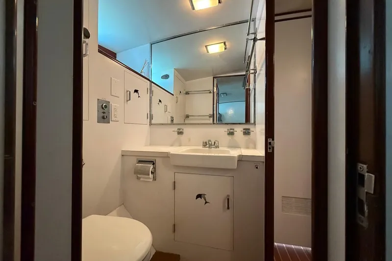 Slide: The Image of Bathroom interior of a 1963 Rybovich 45 Convertible yacht, featuring a sink and mirror. - 49