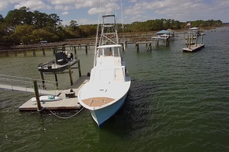 Slide: The Image of 1963 Rybovich 45 Convertible yacht docked at a serene marina. - 5