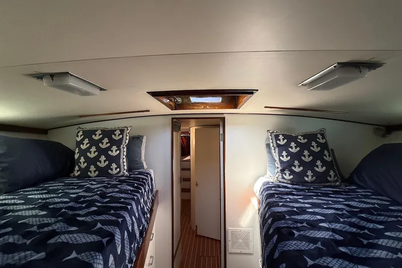 Slide: The Image of Interior cabin of a 1963 Rybovich 45 Convertible with nautical-themed bedding. - 50