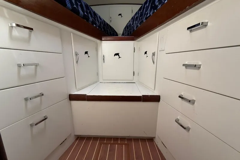 Slide: The Image of Interior of 1963 Rybovich 45 Convertible boat with white cabinetry and wood accents. - 51