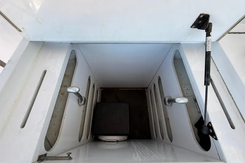 Slide: The Image of 1963 Rybovich 45 Convertible boat interior with storage compartments and hydraulic support. - 54