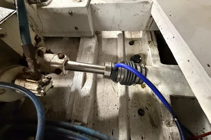 Slide: The Image of Engine compartment of a 1963 Rybovich 45 Convertible boat, showing mechanical components and hoses. - 58