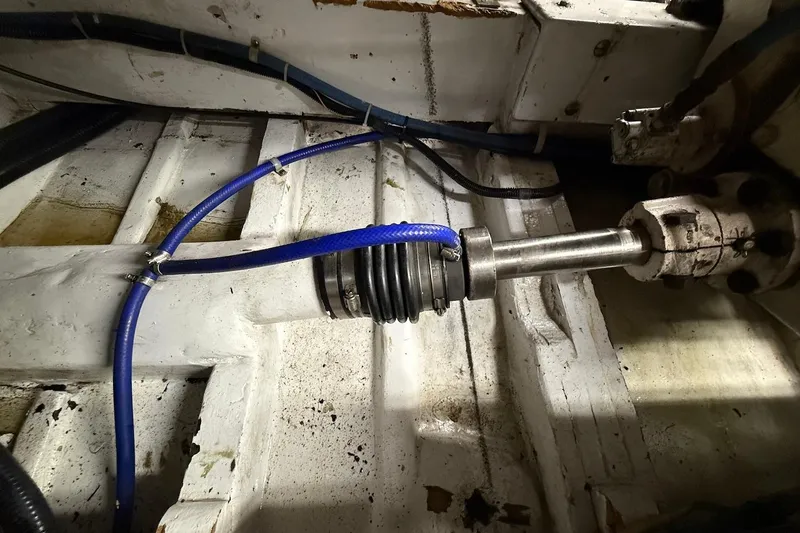 Slide: The Image of Engine room of 1963 Rybovich 45 Convertible boat showing mechanical components and blue hose. - 59