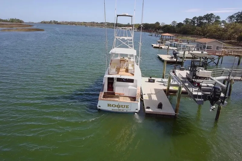 Slide: The Image of 1963 Rybovich 45 Convertible yacht docked at marina, aerial view. - 6