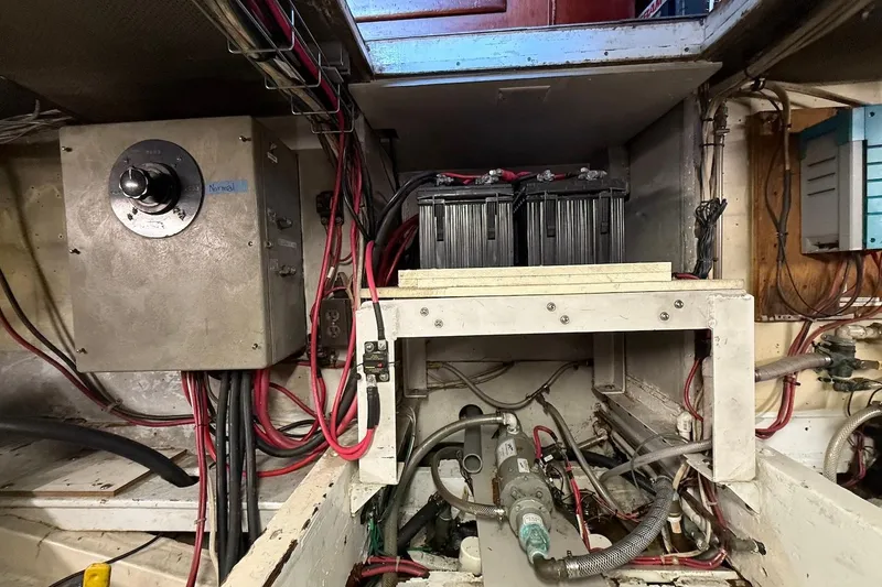Slide: The Image of Engine room of a 1963 Rybovich 45 Convertible boat, showing electrical components and wiring. - 60