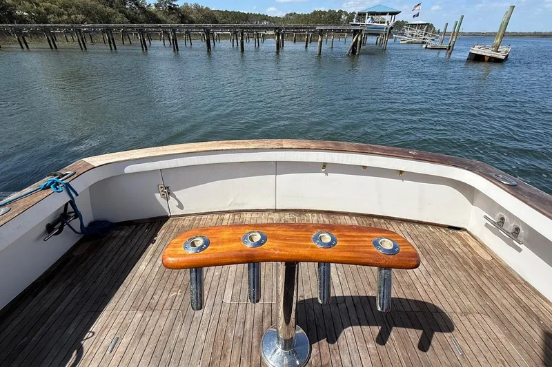 Slide: The Image of 1963 Rybovich 45 Convertible boat deck with fishing rod holders, dock view. - 8