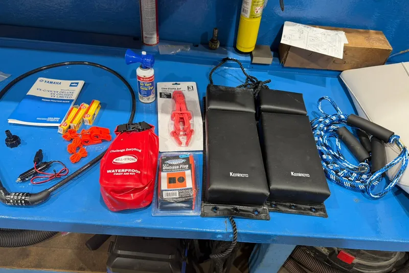 Slide: The Image of Assorted Yamaha WaveRunner VX Cruiser 2022 accessories on a blue workbench. - 16
