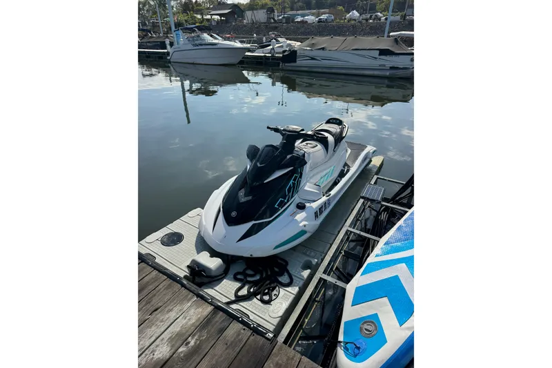 Slide: The Image of 2022 Yamaha WaveRunner VX Cruiser docked at marina, surrounded by calm water and boats. - 17